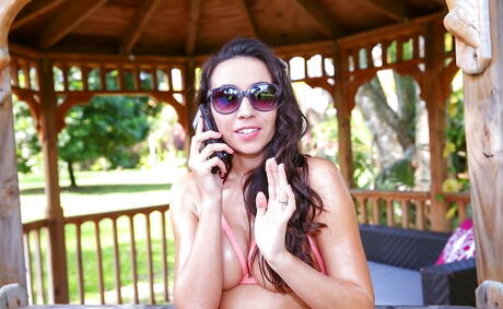 Sexy brunette milf Stephanie Moretti in glasses shows big titties and hot ass outdoor